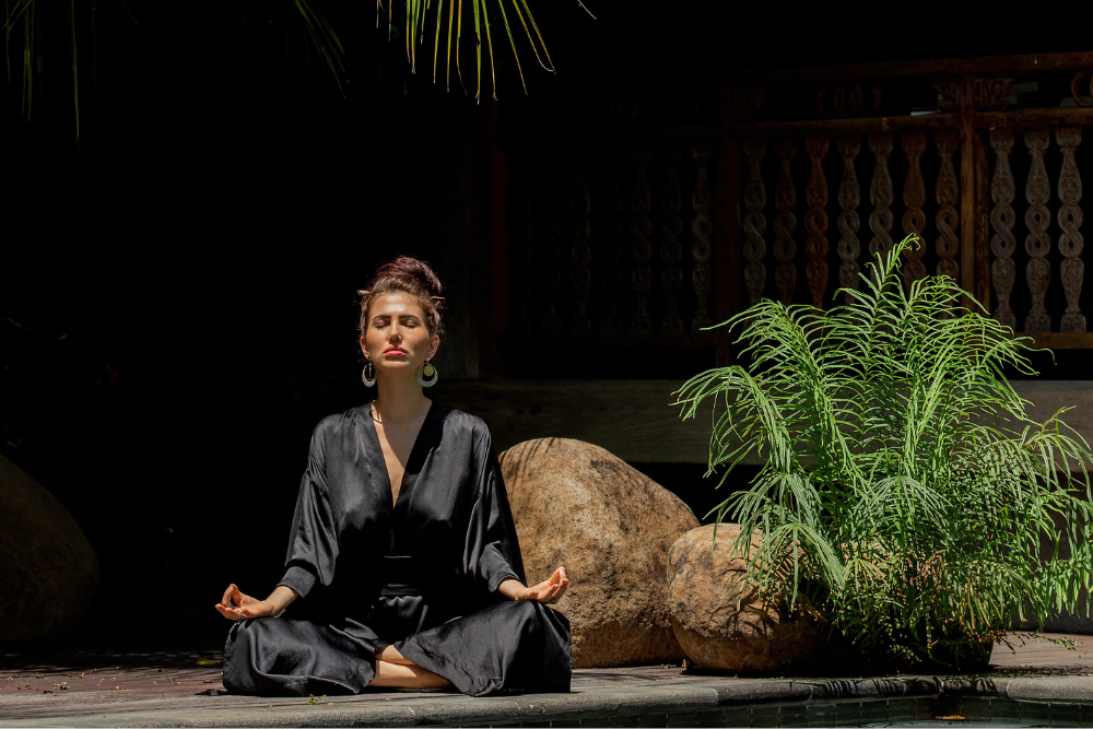 Serene meditation at an ayahuasca retreat in Mexico, with a tranquil outdoor setting promoting deep spiritual healing and self-discovery.