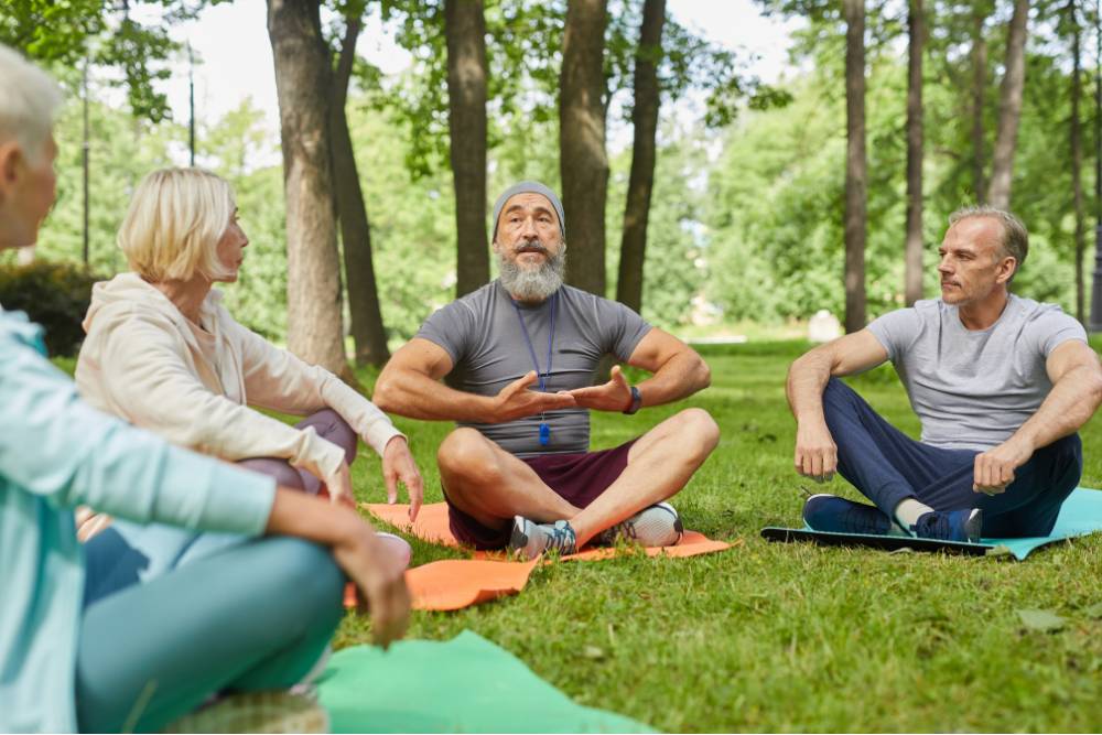 A group of participants engaged in a guided outdoor session during San Pedro Retreats in Colombia, surrounded by peaceful forest nature.