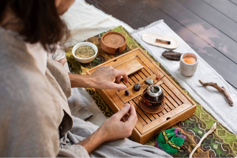 A man engaged in a traditional ceremony setup with herbs and sacred objects, representing rituals that explore what does the San Pedro cactus do for consciousness.